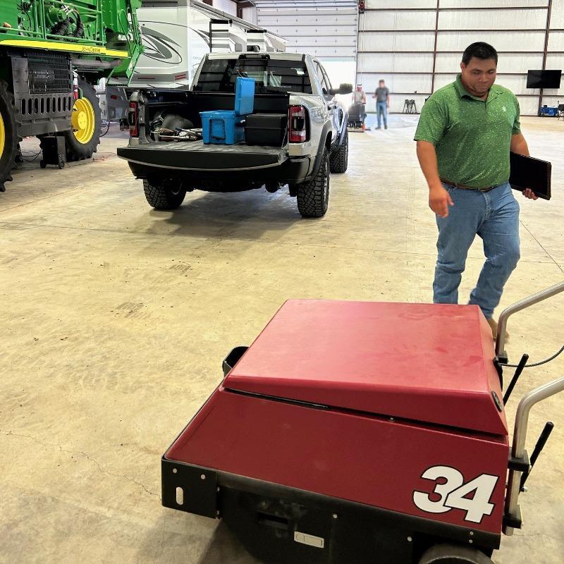 FactoryCat Walk Behind Floor Sweepers 34 barn concrete - https://assets.factorycat.com/demoImages/2025/april/34-Walk Behind Floor Sweepers-barn-concrete-Kansas City-USA-456.jpg - 800 - 800 - 456 A FactoryCat 34 battery floor sweeper cleaning the concrete floor of service barn on a farm in Kansas City, MO