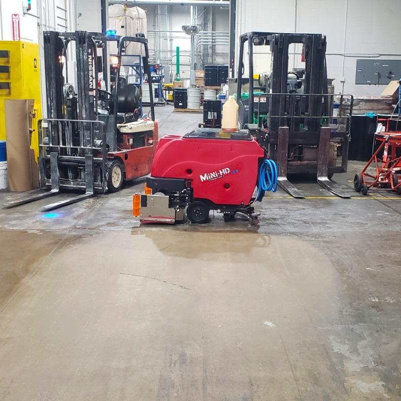 FactoryCat Ride On Floor Scrubbers GTR garage concrete - https://assets.factorycat.com/demoImages/2025/april/GTR-Ride On Floor Scrubbers-garage-concrete-Miami-USA-642.jpg - 800 - 800 - 642 GTR Ride On Floor Scrubber cleaning the concrete floor in a maintenance garage a a university in Miami, Florida