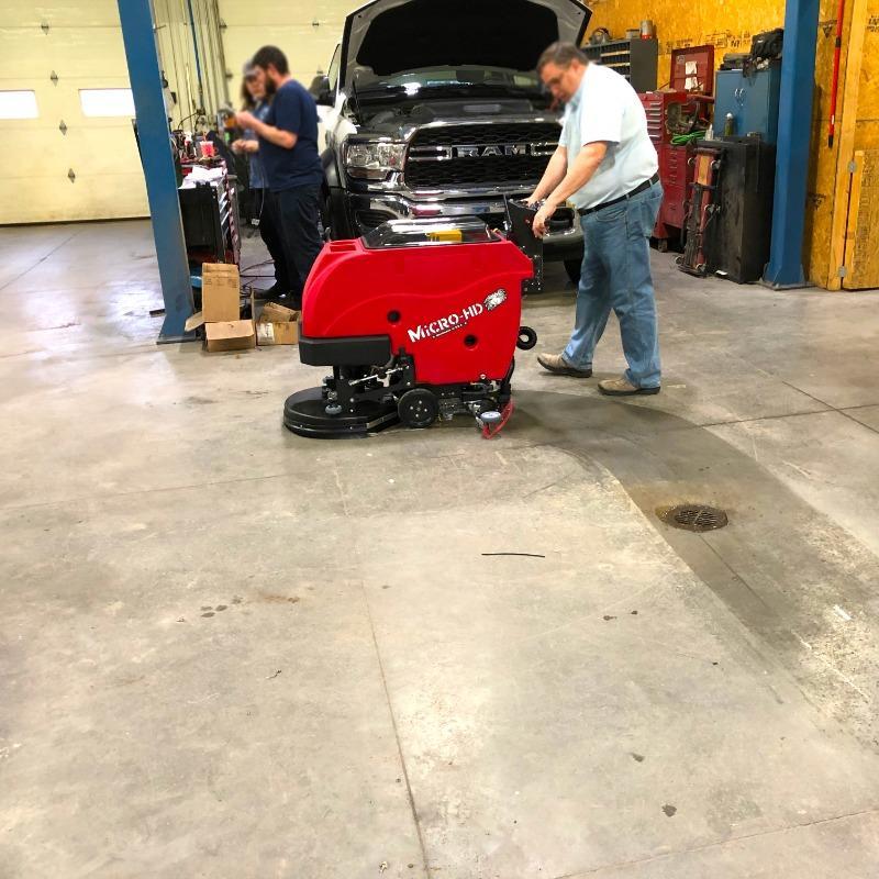 FactoryCat Walk Behind Floor Scrubbers Micro-HD service bay concrete - https://assets.factorycat.com/demoImages/2025/april/Micro-HD-Walk Behind Floor Scrubbers-service bay-concrete-Evansville-USA-941.jpg - 800 - 800 - 941 A FactoryCat Micro-HD walk behind floor scrubber cleans the concrete floors of a service bay at an Evansville, Indiana automobile repair shop