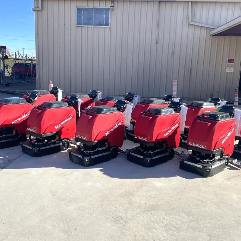 FactoryCat Walk Behind Floor Scrubbers MicroMag garage concrete - https://assets.factorycat.com/demoImages/2025/april/MicroMag-Walk Behind Floor Scrubbers-garage-concrete-Dallas-USA-389.jpg - 800 - 800 - 389 A large order of FactoryCat Micro Mag walk behind auto scrubbers ready for delivery to a contract cleaner in Texas.