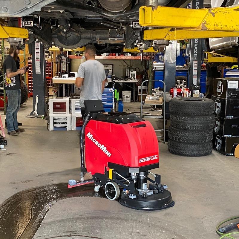 FactoryCat Walk Behind Floor Scrubbers MicroMini service bay concrete - https://assets.factorycat.com/demoImages/2025/april/MicroMini-Walk Behind Floor Scrubbers-service bay-concrete-Los Angeles-USA-307.jpg - 800 - 800 - 307 A MicroMag floor scrubber cleans a service bay of a an auto repair shop in in Los Angeles, CA.