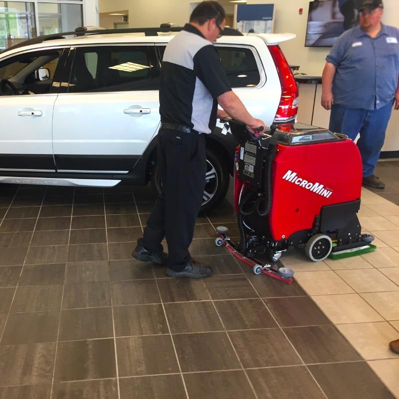 FactoryCat Walk Behind Floor Scrubbers MicroMini showroom tile floors - https://assets.factorycat.com/demoImages/2025/april/MicroMini-Walk Behind Floor Scrubbers-showroom-tile floors-Towson-USA-868.jpg - 800 - 800 - 868 A FactoryCat MicroMini Walk Behind Floor Scrubber cleans the tile floor in a showroom and a Towson, Maryland auto dealers