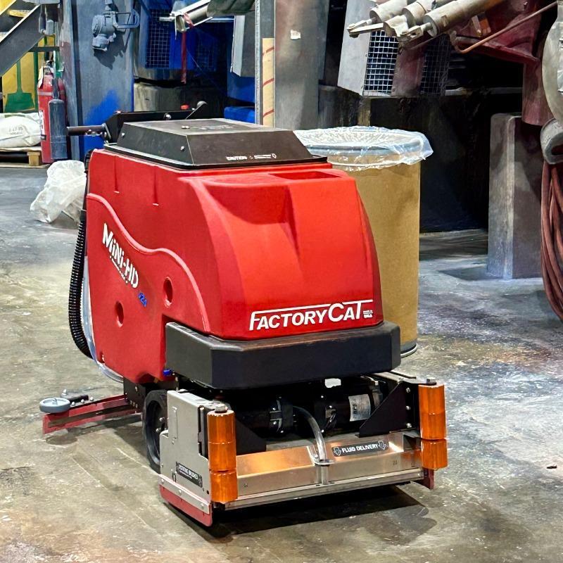 FactoryCat Walk Behind Floor Scrubbers Mini-HD production areas concrete - https://assets.factorycat.com/demoImages/2025/april/Mini-HD-Walk Behind Floor Scrubbers-production areas-concrete-San Antoinio-USA-912.jpg - 800 - 800 - 912 A FactoryCat Mini-HD walk behind floor scrubber cleans the concrete floor of the production area in a San Antonio, Texas chemical plant