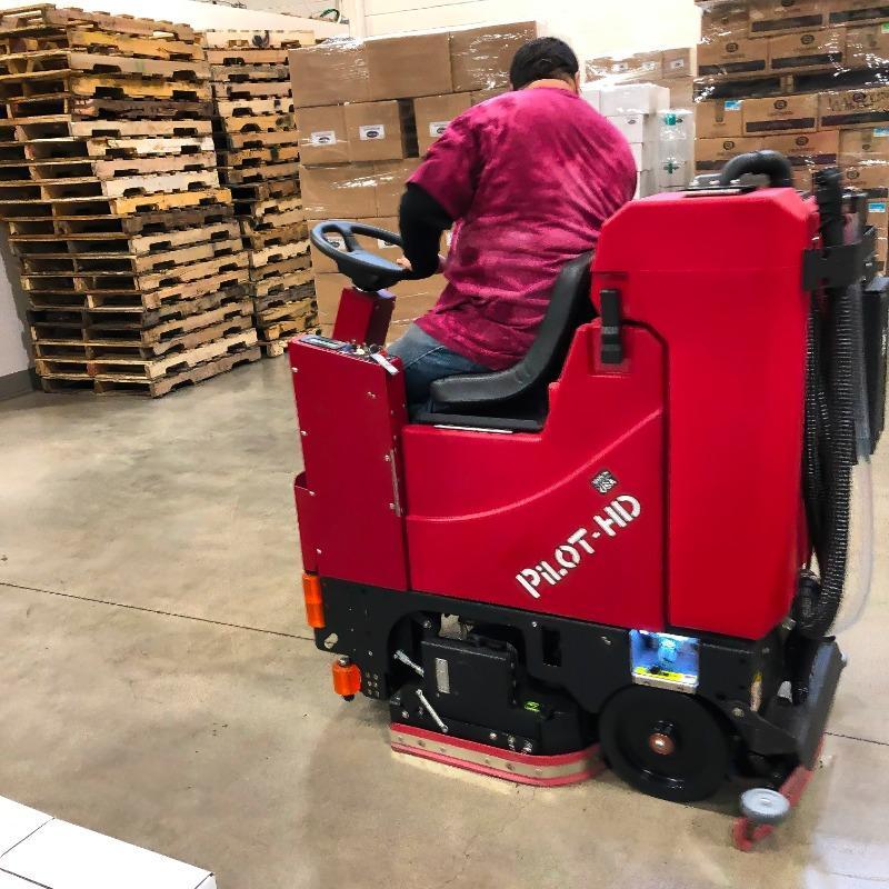 FactoryCat Ride On Floor Scrubbers Pilot warehouse concrete - https://assets.factorycat.com/demoImages/2025/april/Pilot-Ride On Floor Scrubbers-warehouse-concrete-Eau Claire-USA-831.jpg - 800 - 800 - 831 A FactoryCat Pilot Battery Ride On Floor Scrubber cleans the concrete floor of an Eau Claire, Wisconsin Big box retailers